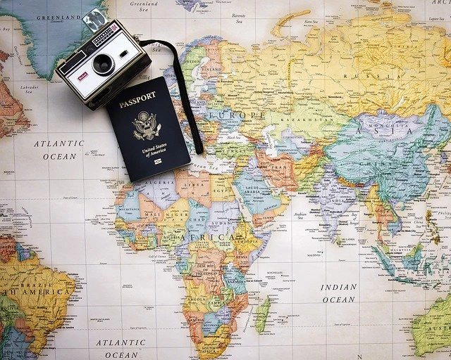 passport and camera on a map